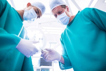 Surgeons performing operation in operation room