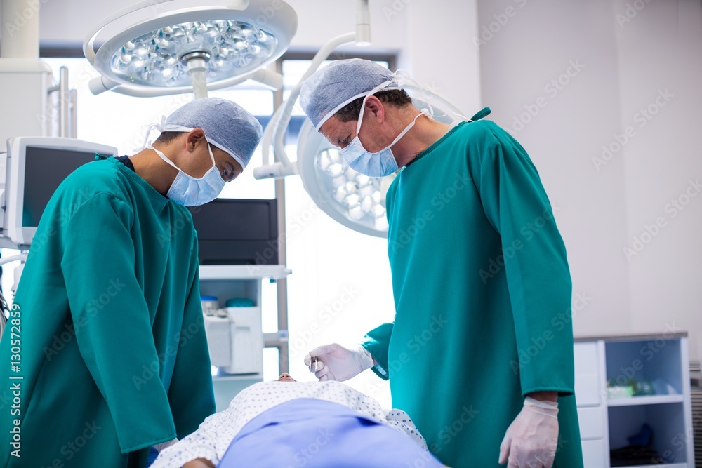 Poster surgeons performing operation in operation room