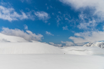 Fototapeta na wymiar High mountains under snow with clear blue sky