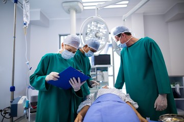 Surgeons performing operation in operation room