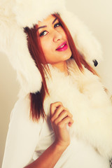 Woman in winter warm clothes fur cap scarf