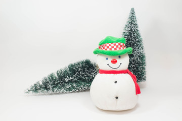 Snowman doll and christmas tree on white background.