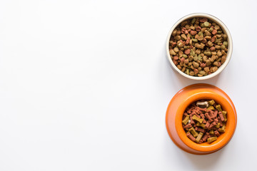 dry pet food in bowl on white background top view
