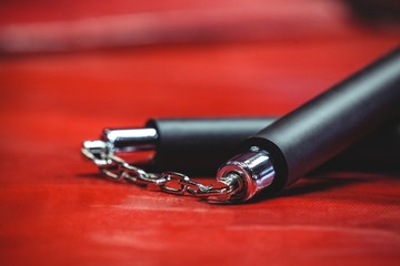 Nunchaku on red background