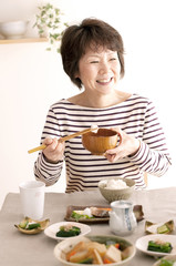 朝食を食べるシニア女性