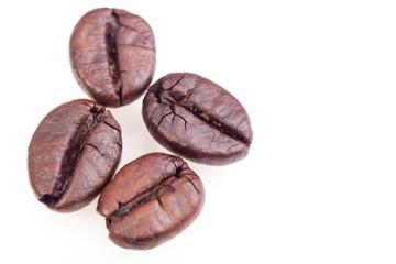 close up of roasted coffee beans. Isolated on white background with clipping path