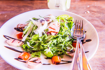 Italian sausage and rocket salad on white dish