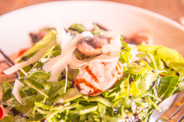 Italian sausage and rocket salad on white dish
