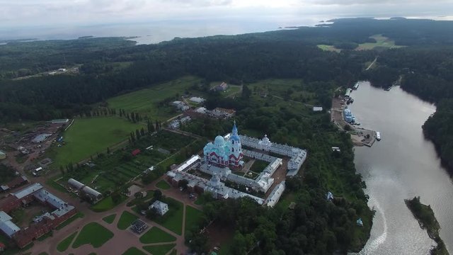 The landscape of the island of Valaam. The camera flies over the Main building of the monastery. Journey to the Holy places. Aerial view.
