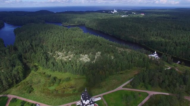 Flying over Valaam island. The landscape of the island of Valaam. The camera flies over water and forest. Journey to the Holy places.