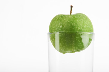 Green apple in glass