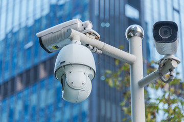 CCTV security camera front of a building in city of China. - Powered by Adobe