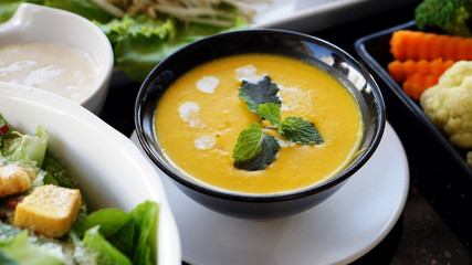 Creamy pumpkin soup serve with other organic food
