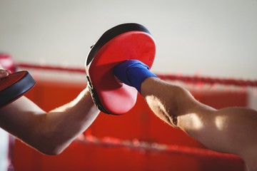 Female boxer practicing in the ring