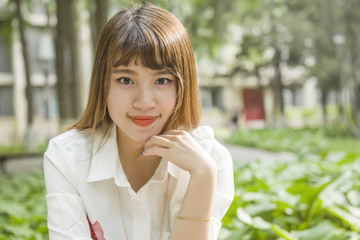 Young asian woman in campus and looking at camera