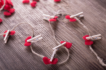 Red textile hearts connected by clothespin. Love concept.