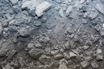 Black coal lying on a pile in house basement