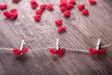 Red textile hearts connected by clothespin. Love concept