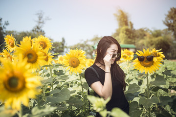Beauty joyful teenage girl with sunflower enjoying nature and la