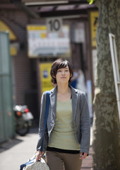 Fototapeta premium Young woman in street