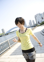 Young woman walking along river