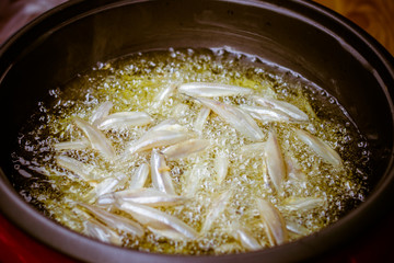  close up of fried small fish in pan sale at asian street market ,cooking style asian, asian kitchen