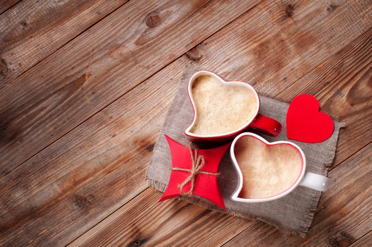 two cups coffee cappuccino gift box wooden table. Mug in shape of heart