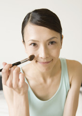 Fototapeta premium A woman having makeup on