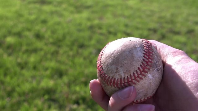 Person with baseball in their hand.  Shot at 240fps.
