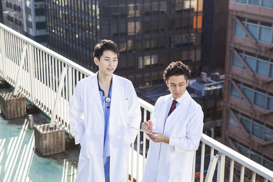 Two male doctors on the roof of the hospital