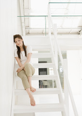Fototapeta na wymiar Young woman sitting on stairs