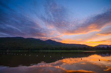 Fototapeta na wymiar Sunset / sunrise reflection on lake with mountain