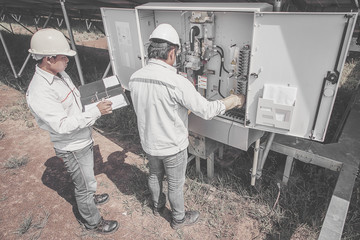 engineer working on checking and maintenance equipment in solar power plant