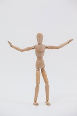 Wooden figurine standing with arms spread wide