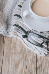 coffee cup with glasses on the scarf and Wooedn in vintage tone