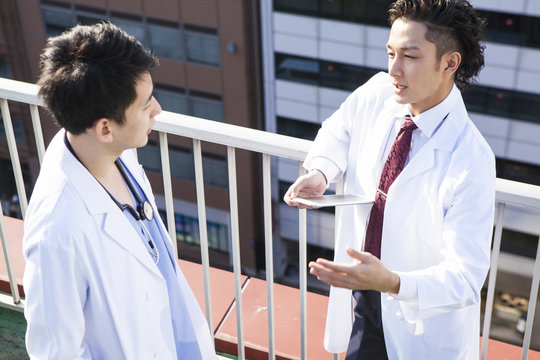 Doctors talking on the hospital's rooftop