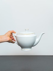 Elegant porcelain white jug and woman hand
