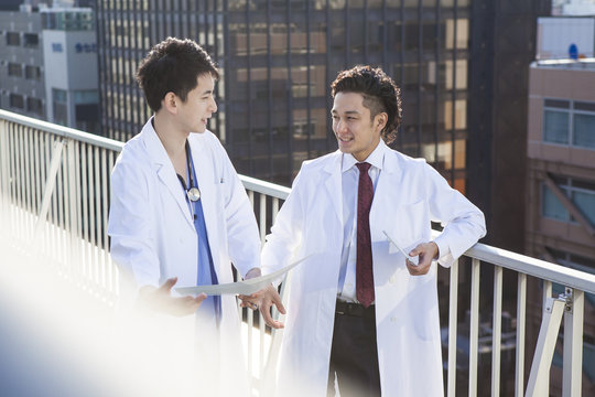 Doctors talking while watching CT images on the hospital's rooftop