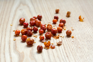 Dried chiltepin chilli pepper on wooden surface