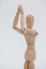 Wooden figurine standing with both the hands joined