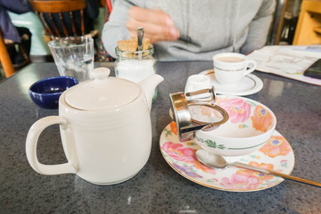 close up teapot with cup and saucer in teatime