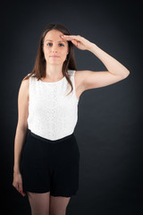 Fototapeta premium Beautiful woman doing different expressions in different sets of clothes: at attention