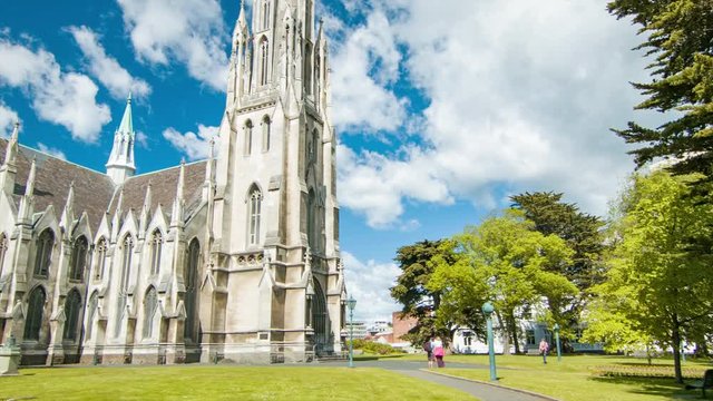 Dunedin New Zealand First Church of Otago Exterior Tilting Up to Tower on a Sunny Day with Blue Sky and White Clouds