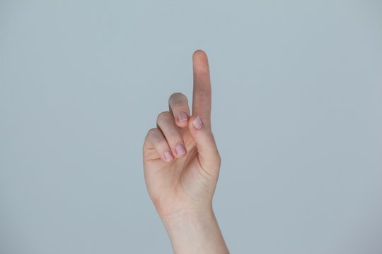 Hand of a woman pointing upwards