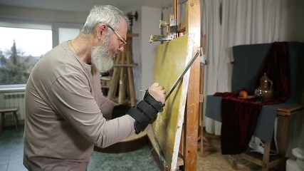 Artist working on painting.