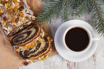Poppy seeds cake, cup of coffee and spruce branches, dessert for Christmas