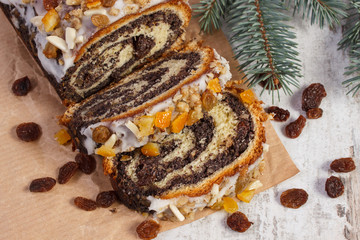 Homemade poppy seeds cake and spruce branches, dessert for Christmas