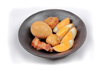 Ready stewed boiled egg with tofu and streaky pork served.
