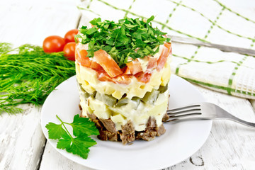 Salad with beef and tomato on light board