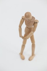Wooden figurine standing with hands on knee